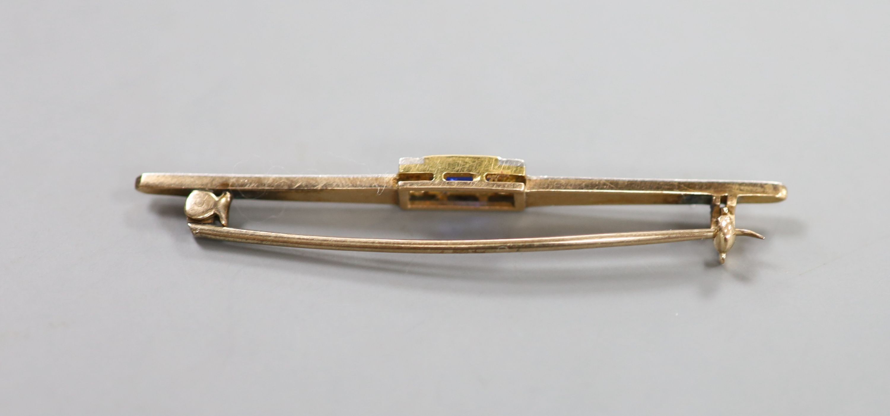 A 1930's/1940's yellow metal, synthetic sapphire and diamond chip set bar brooch, 55mm, gross weight 4.2 grams.